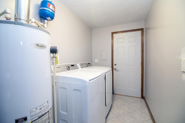 washroom featuring light tile patterned flooring, independent washer and dryer, a textured ceiling, and water heater