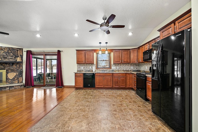 kitchen with ceiling fan, tasteful backsplash, pendant lighting, lofted ceiling, and black appliances