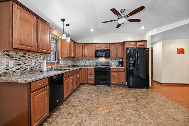 kitchen with ceiling fan, sink, black appliances, decorative light fixtures, and lofted ceiling