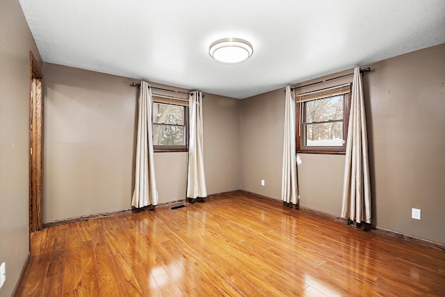 unfurnished room with light hardwood / wood-style flooring