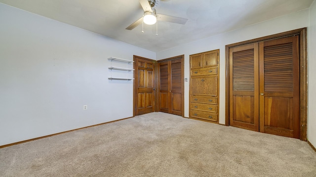 unfurnished bedroom with ceiling fan and carpet