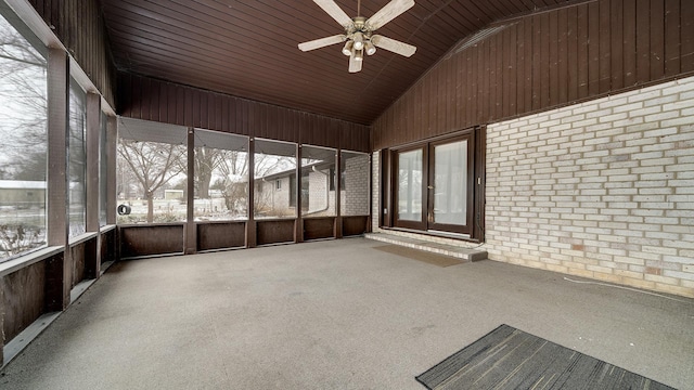 unfurnished sunroom with ceiling fan and vaulted ceiling