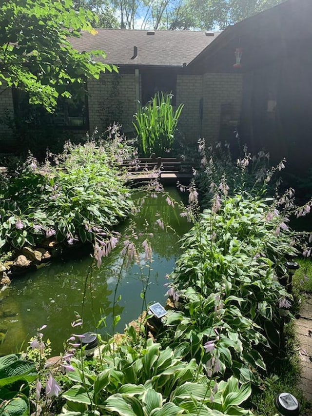 exterior space with a garden pond