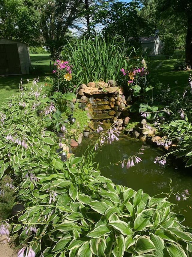 view of landscape featuring a garden pond