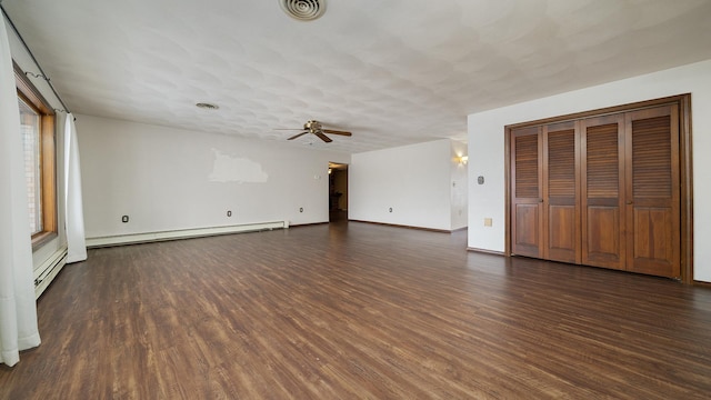 interior space with baseboard heating, ceiling fan, dark hardwood / wood-style flooring, and a textured ceiling