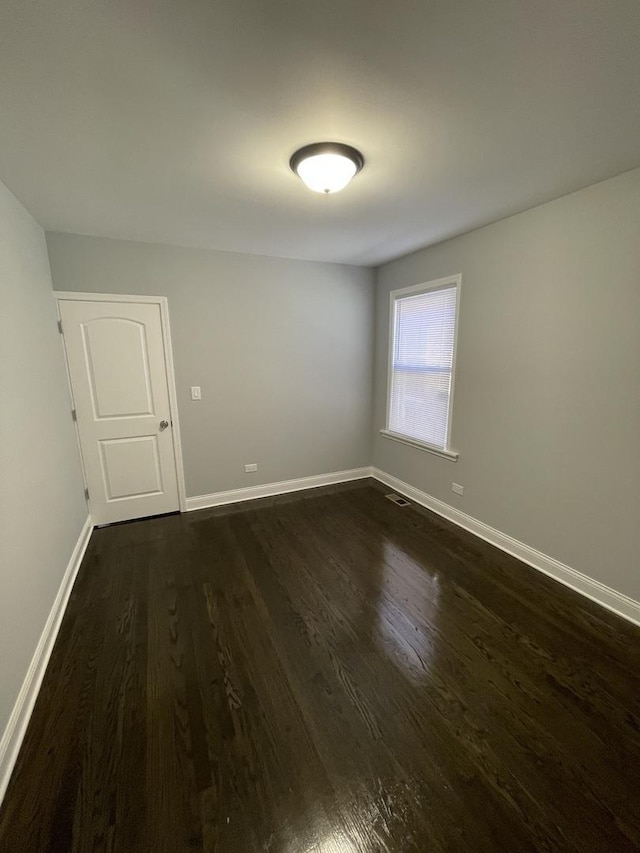 empty room with dark hardwood / wood-style floors