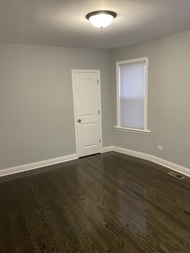 spare room featuring dark hardwood / wood-style floors