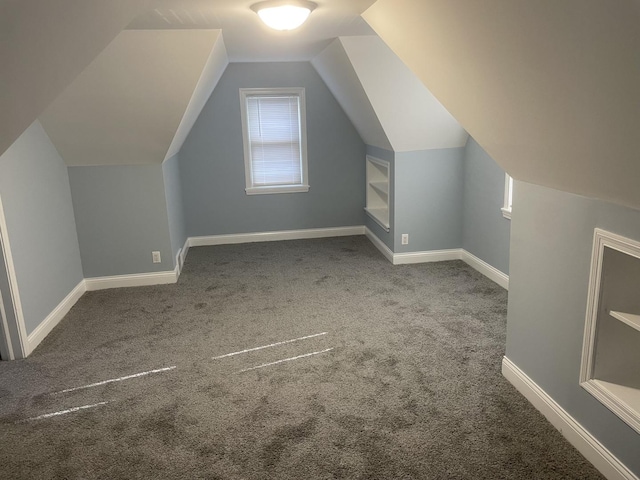 bonus room with carpet and vaulted ceiling