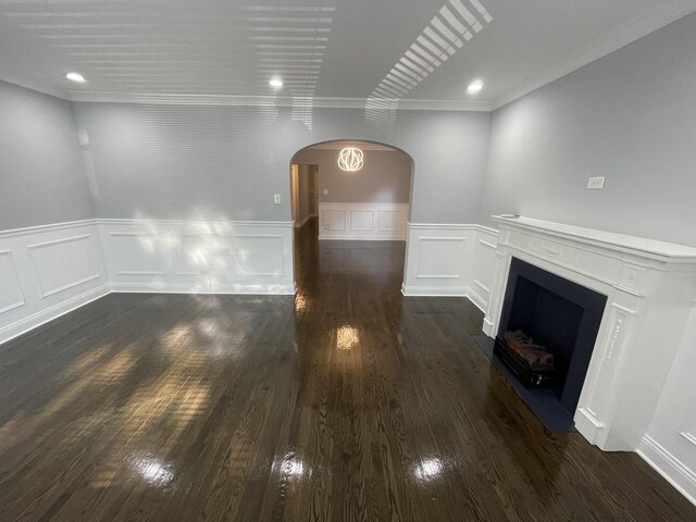 unfurnished living room featuring crown molding and dark hardwood / wood-style flooring