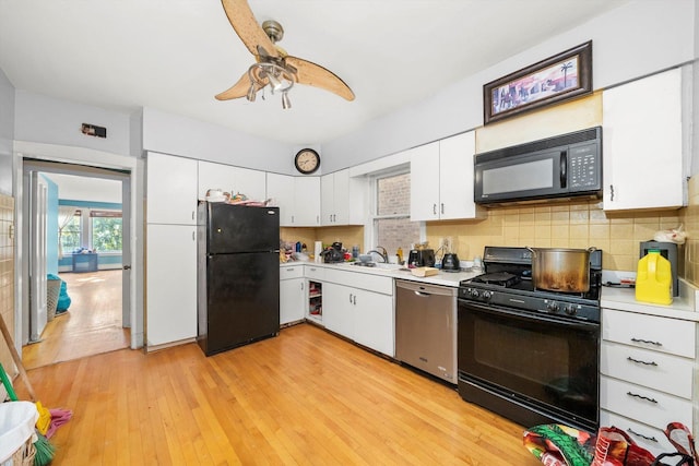 kitchen featuring backsplash, black appliances, light hardwood / wood-style flooring, ceiling fan, and white cabinetry