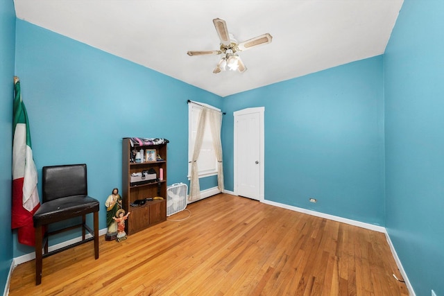 living area with ceiling fan and light hardwood / wood-style floors