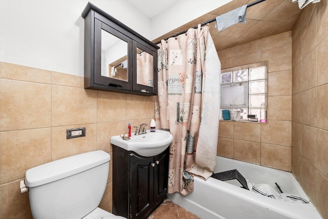 full bathroom featuring vanity, shower / bathtub combination with curtain, toilet, and tile walls