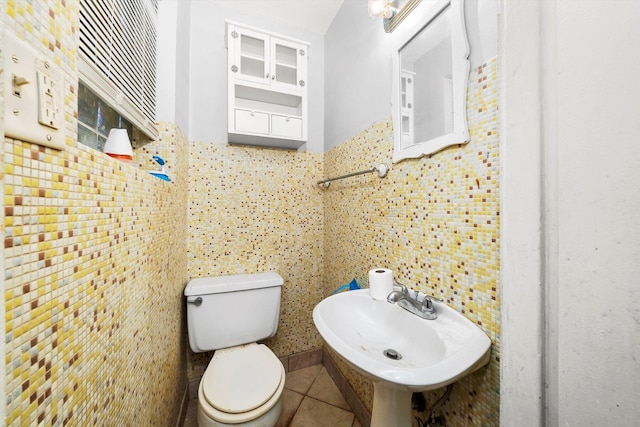 bathroom featuring tile patterned flooring, toilet, and sink