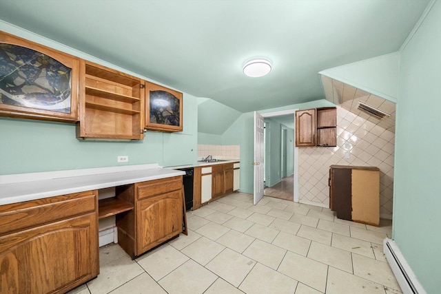 kitchen with light tile patterned floors, lofted ceiling, a baseboard heating unit, and sink