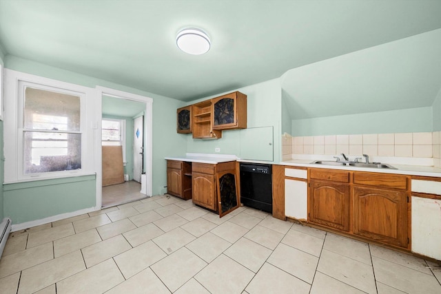 kitchen with dishwasher, sink, a baseboard heating unit, decorative backsplash, and light tile patterned floors