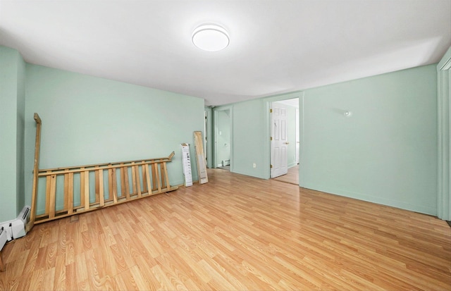 spare room with light hardwood / wood-style flooring and a baseboard radiator