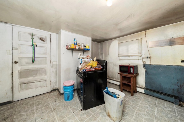 basement with washer / dryer and a baseboard radiator