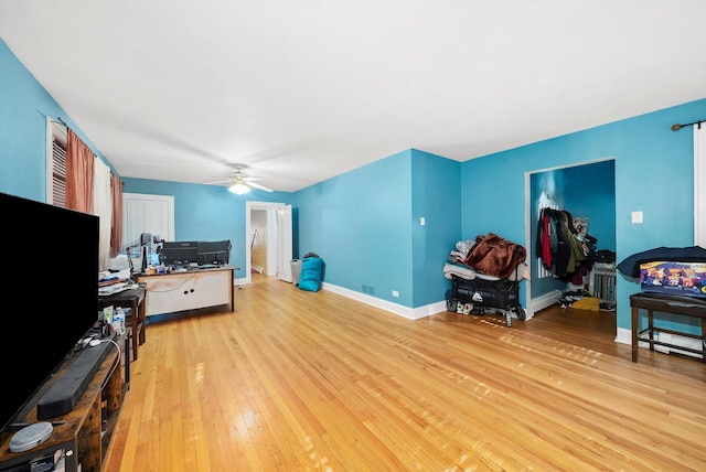 living room with ceiling fan and light hardwood / wood-style floors