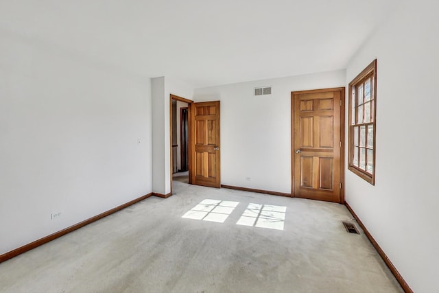 unfurnished bedroom featuring light colored carpet