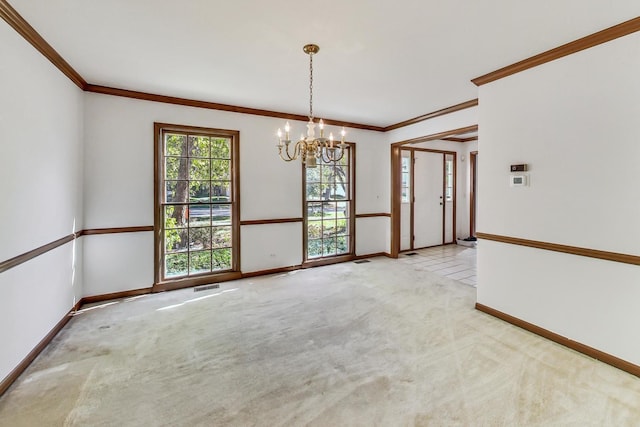 carpeted spare room with ornamental molding and a notable chandelier