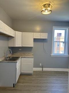 kitchen featuring sink, white cabinets, and dark hardwood / wood-style floors