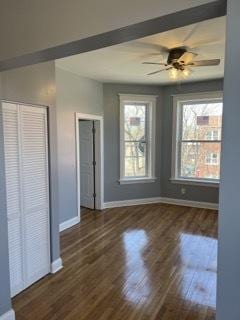 interior space with ceiling fan and dark wood-type flooring