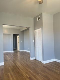 empty room with dark wood-type flooring