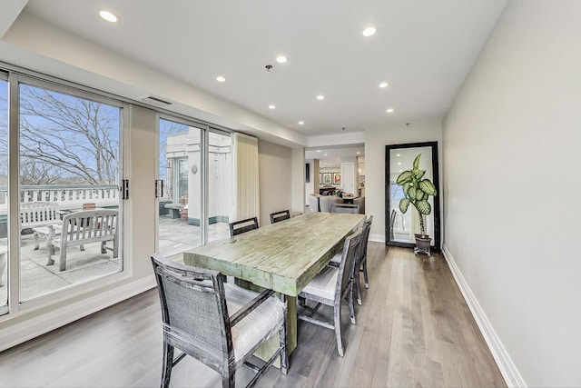 dining room featuring a wealth of natural light and light wood-type flooring