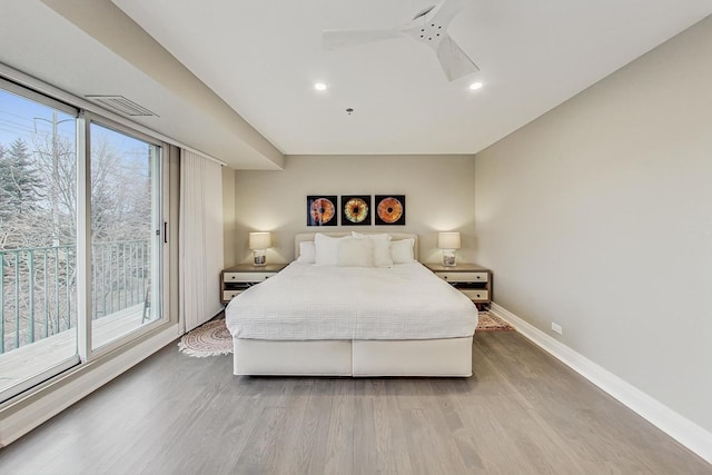 bedroom with hardwood / wood-style flooring, ceiling fan, access to outside, and multiple windows