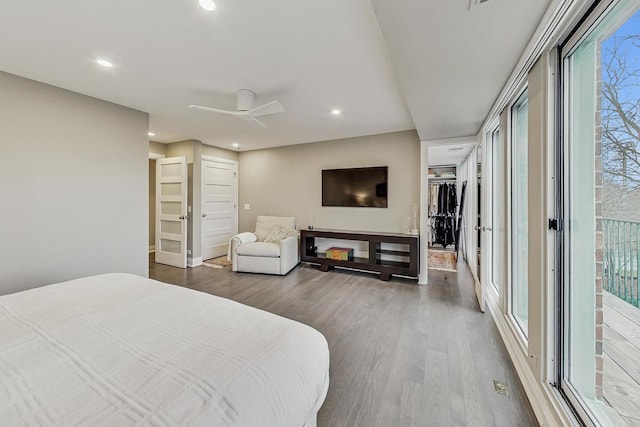 bedroom with ceiling fan, dark hardwood / wood-style floors, and access to outside