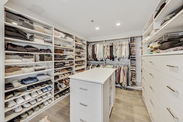 walk in closet with light wood-type flooring