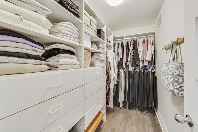 walk in closet featuring light hardwood / wood-style flooring