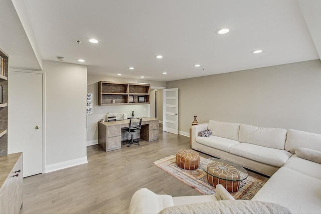 living room featuring built in desk and light wood-type flooring