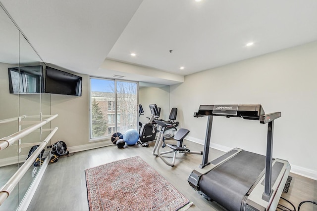 workout room with light hardwood / wood-style flooring