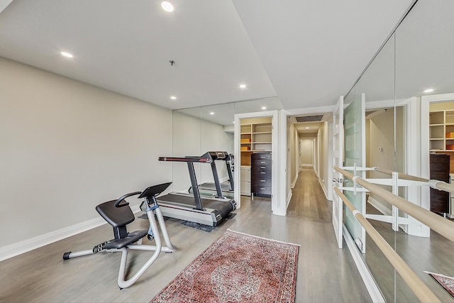 exercise area featuring light hardwood / wood-style floors