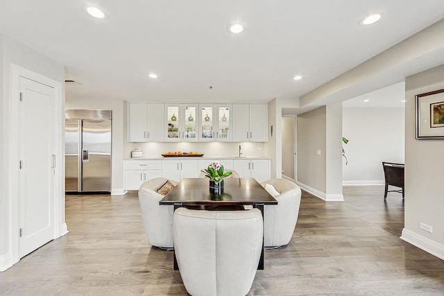 dining area with sink and light hardwood / wood-style flooring