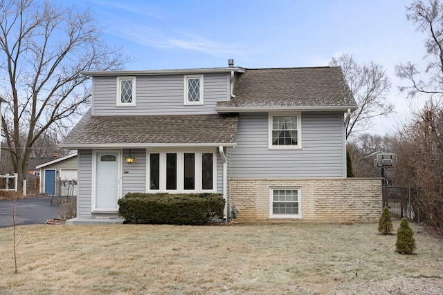 rear view of house featuring a yard