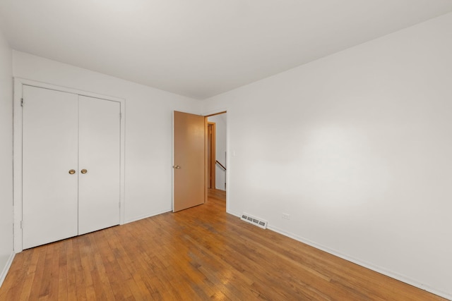 unfurnished bedroom featuring a closet and light hardwood / wood-style floors