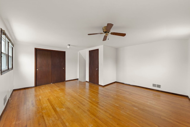 spare room with ceiling fan and light wood-type flooring