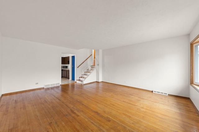 empty room with hardwood / wood-style flooring