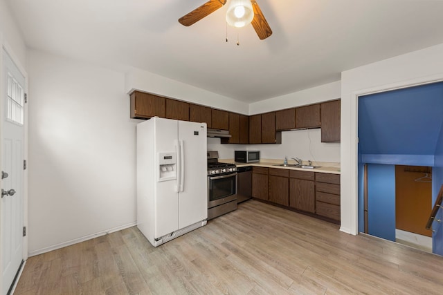 kitchen featuring light hardwood / wood-style floors, dark brown cabinetry, sink, and appliances with stainless steel finishes