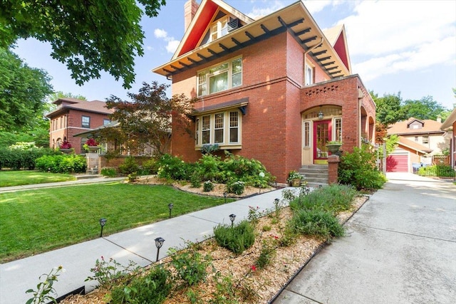 view of front of property featuring an outbuilding, a garage, and a front lawn