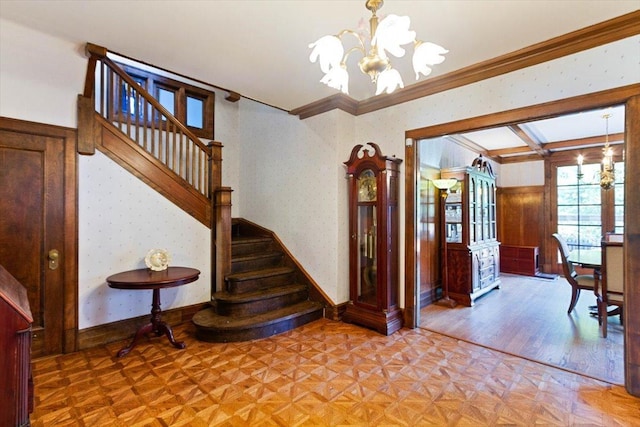 interior space featuring ornamental molding, an inviting chandelier, and parquet floors