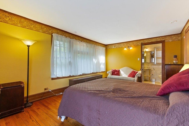 bedroom featuring hardwood / wood-style floors and multiple windows