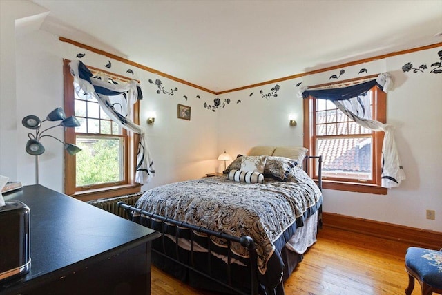 bedroom featuring ornamental molding and hardwood / wood-style floors