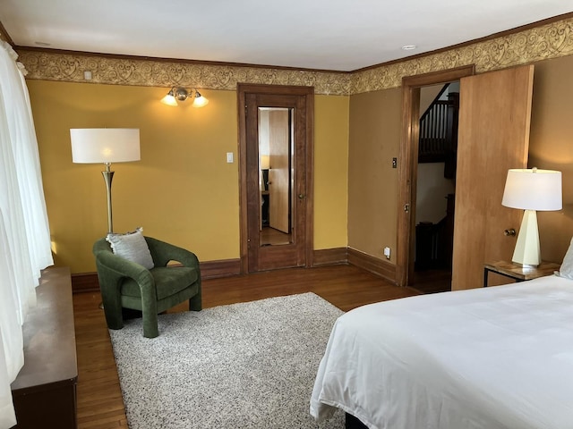 bedroom featuring dark hardwood / wood-style floors and ornamental molding