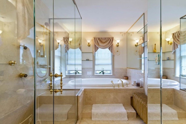 bathroom featuring a wealth of natural light and shower with separate bathtub