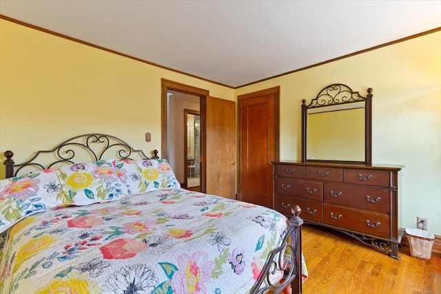 bedroom with ornamental molding and light hardwood / wood-style flooring