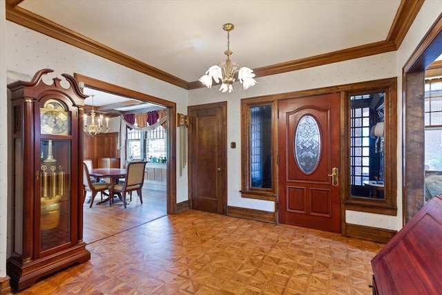 entryway featuring a notable chandelier, ornamental molding, and light parquet floors