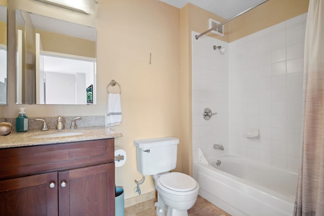 full bathroom featuring toilet, tile patterned floors, vanity, and shower / bath combo with shower curtain